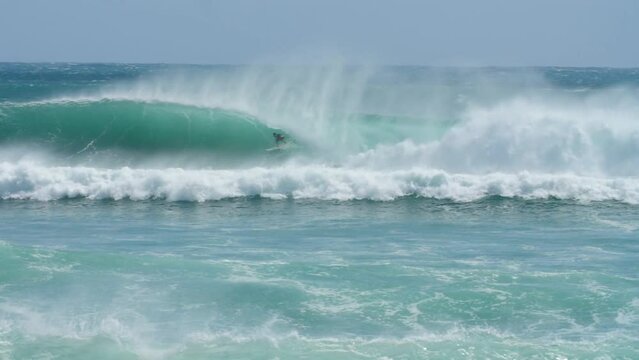 surfer riding perfect barrel at cyclone Oma, Australia