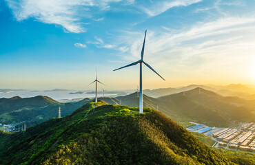 Wind turbines and green mountain nature landscape near the sea.  Green energy concept.  aerial view. - obrazy, fototapety, plakaty