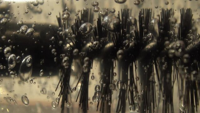 Cosmetic oil for the growth of eyebrows and eyelashes with a brush.