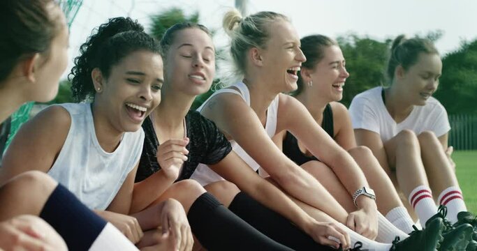 Happy woman, soccer and team laughing for funny joke, meme or social on green grass field. Female person or athlete group of football players smile enjoying conversation, break or rest after match