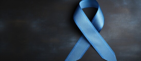 Blue ribbon signifies November campaign for prostate cancer awareness and men's health on denim jeans.