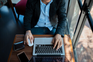 Businessman uses smartphone to share internet connection to analyze investment risks in the stock market
