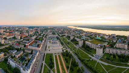 Fototapeta na wymiar Perm, Russia - August 3, 2020: Central part of the city of Perm. View of the Kama river. Panorama during sunset. Aerial view