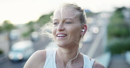Woman, earphones and music on bridge by fitness watch, happy and exercise glow in city for training. Young person, runner or streaming playlist for workout, sport wellness or cardio by urban highway - Powered by Adobe