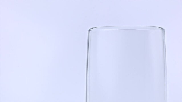 Surface tension of water. Science experiment - white background, crystal glass