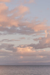 Pastel sunset clouds over calm ocean in Dominican Republic.