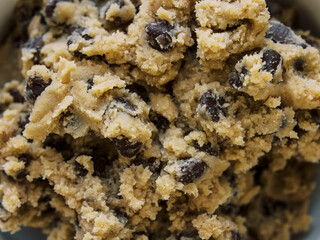 homemade cookie dough in white bowl on white marble background