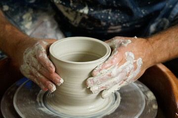 Fototapeta na wymiar Throwing a bowl on a pottery wheel