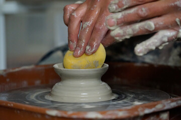 Man throwing a bowl with a sponge on a wheel