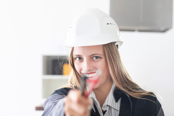 Young engineer female with helmet in a work shop