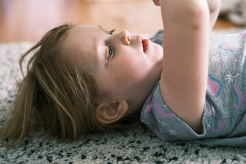 Obraz na płótnie Canvas Happy child lying on the floor