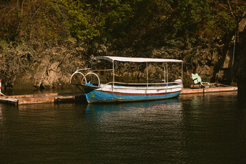 A boat on the green water of Matka Lake