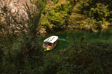 A boat on the green water of Matka Lake