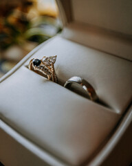 Close up of diamond wedding rings and band in a ring box