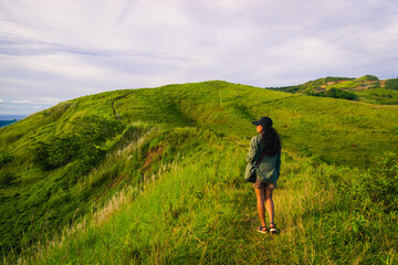 Woman on a mountain at sunset. Cabaliwan Peak, Romblon, Philippines