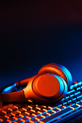 Headphones on a computer keyboard on black background