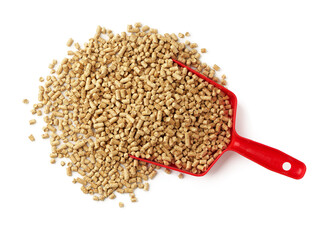 Cat litter in a red plastic scoop on white background