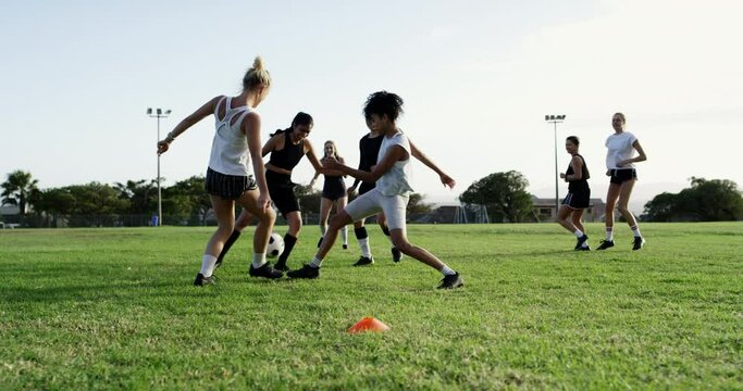 Woman, soccer and playing with ball on green grass field in team sports, kicking or outdoor dribbling. Female person, people or athlete group in football match, sport game or passing in competition