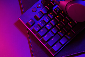 Headphones on a computer keyboard on black background