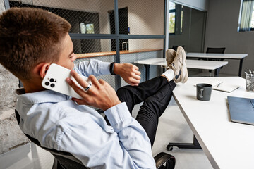 Handsome businessman using smartphone in the office