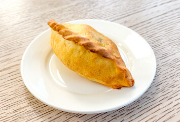 Pie in a white plate on the table