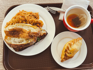 Bread with cabbage in a plate, pie and tea