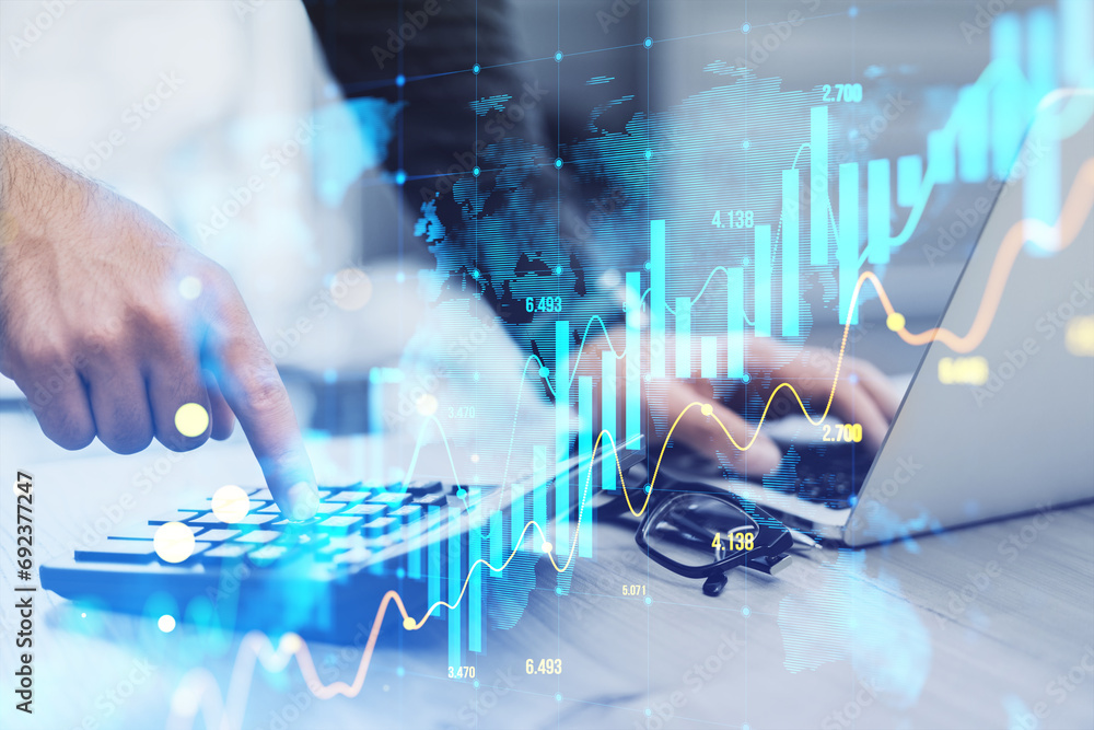 Poster close up of hand using laptop and calculator with glowing candlestick forex chart on blurry backgrou