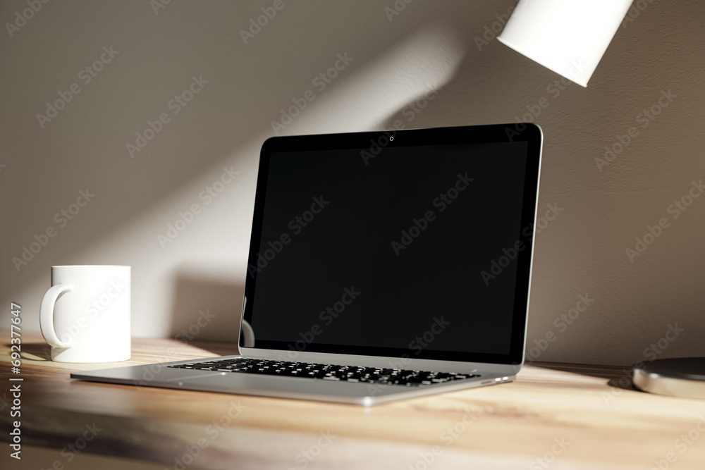 Poster modern blurry daytime desktop with blank laptop screen, lamp and coffee cup. designer workspace conc
