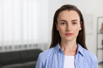 Portrait of beautiful woman indoors, space for text