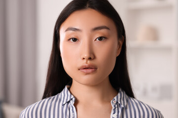 Portrait of beautiful young woman on blurred background