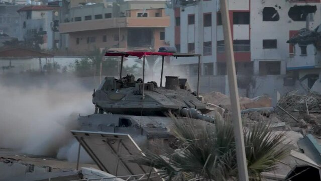Israeli  Merkava Mark IV tank patrols through the destroyed streets of Gaza