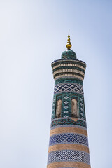 Ancient minaret Islam Khoja Minaret on a sunny summer day in the ancient city of Khiva in Khorezm