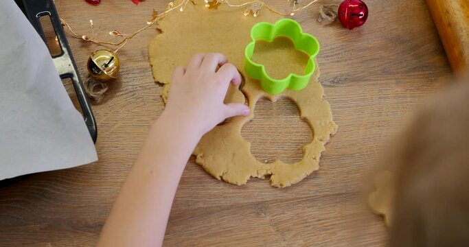 Close footage of girl making ginger bread cookies forms and preparing for baking