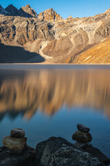 View of Lake Gokyo and snow capped mountains in Gokyo settlement at dawn during trekking to Everest base camp EBC or Three Passes Trek in Nepal, Solukhumbu, Sagarmatha, Nepal.