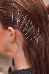 Women's stylish hairstyle with metal bobby pins