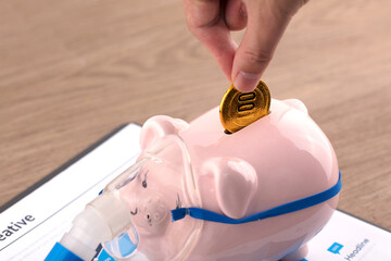 Saving money in a sick piggy bank for medical insurance