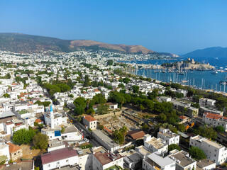 Beautiful scenery of Bodrum city, marina and ancient St. Peter's Castle or Kalesi Castle on a sunny day, Turkey.