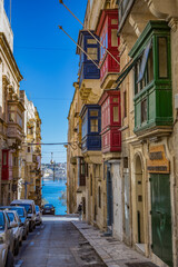 A characteristic alley with coloraded balconies in Valletta city, capital of Malta - 692400854