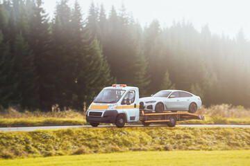 How to Deal with a Car Breakdown on the Road. A Tow Truck Service Helping a Vehicle with Damage....