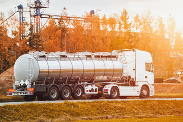 Dangerous goods transportation by semi truck with propane tank. The tank truck has a side view and...