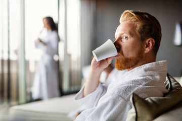 Adult handsome man in bathrobe enjoying spa day and relaxing in comfortable wellness hotel
