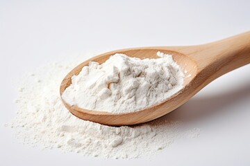 Flour in wooden spoon on white background