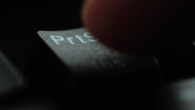 Keyboard button PrtSc. Macro shot of finger pressing Print Screen button