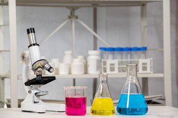 Erlenmeyer flask and beaker with microscope and liquid