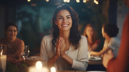 Beautiful woman clapping hands while sitting at dinner table with friends. Female at a gala dinner party with people at dining table. - obrazy, fototapety, plakaty