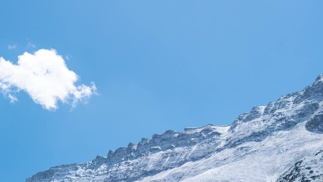 4K timelapse of clouds above seven sister peaks in Lahaul, India. Clouds over snow covered mountains. Himalayas timelapse. Mountain nature landscape. Fresh snow on mountains during sunrise 