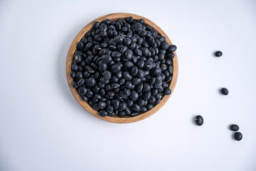 
Black beans, beans, wooden plate, close-up, white background