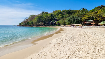 Koh Samet Island Rayong Thailand, the white tropical beach of Samed Island with a turqouse colored ocean on a sunny day with beach chairs on the beach