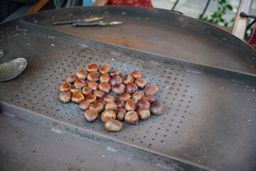 traditional festive food at Christmas market. Fire roasted chestnuts 