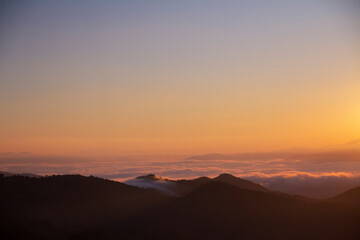 landscape and sky background concept, nature of north Thailand, fog-laden valleys, wintery mountain passes of Chiang mai province, top view on the mountain sunrise.
